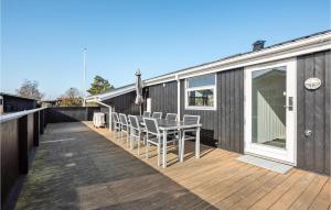 a wooden deck with a table and chairs on a house at Holiday Home As Strandby Juelsminde X in Sønderby +22 photos
