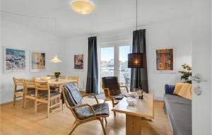 a living room with a couch and a table at Stunning Apartment In Rudkøbing in Rudkøbing