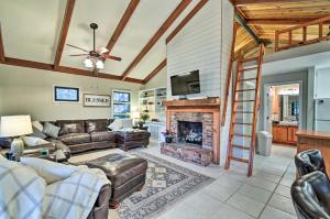 a living room with a couch and a fireplace at Rockingham Cabin on 75 Acres with Lake Access! in Rockingham