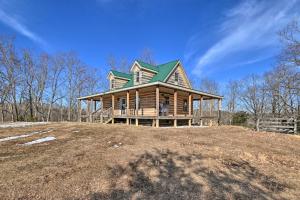 a large house on top of a hill at Quiet and Secluded Berea Cabin on 70-Acre Farm! in Berea