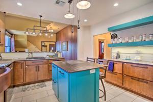 a large kitchen with blue cabinets and a blue island at Pet-Friendly OKC Home with Yard about 5 Mi to Dtwn! in Oklahoma City
