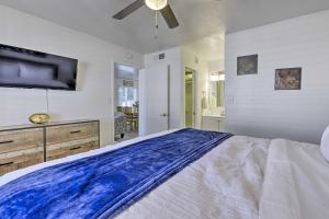 a large bedroom with a large bed and a flat screen tv at Downtown Gilbert Condo with Screened Porch! in Gilbert