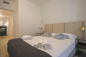 a bedroom with a large white bed with towels on it at MILAN Lux Apartment-Hosted by Sweetstay in Milan