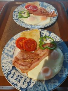 two plates of food with meat and tomatoes on a tray at Agia Roumeli Hotel in Agia Roumeli