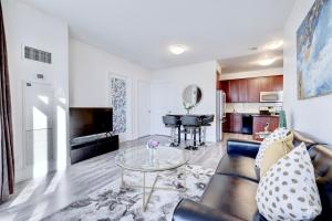 a living room with a couch and a table at Grand Royal condos SQ One Mississauga in Mississauga