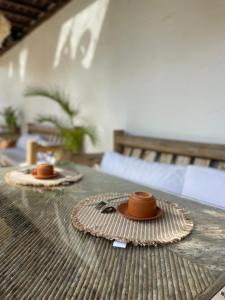 two brown hats sitting on top of a table at Ronco do Mar Jeri in Jericoacoara