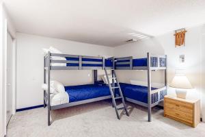 a bedroom with two bunk beds and a lamp at Sugarloaf Mountain Treasure in Carrabassett