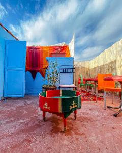 un grupo de sillas y mesas coloridas en un patio en RIAD BORJ JAMAA LAFNA en Marrakech