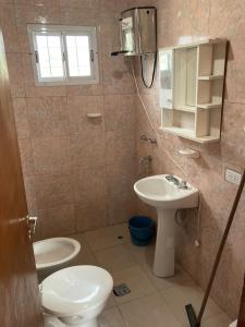 a bathroom with a sink and a toilet and a mirror at Cabañas de Dario, Divino Tesoro in Alumbrera