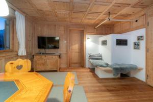 a living room with a table and a tv at Haus Buachwald in Schruns