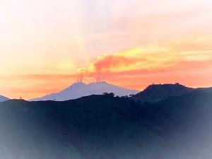 a view of a mountain with a sunset in the background at Casa Francesco in Forza dʼAgro