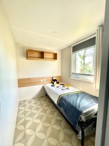 a bedroom with a bed in the corner of a room at Camping le lac des rêves L'ABRIZEN in Lattes