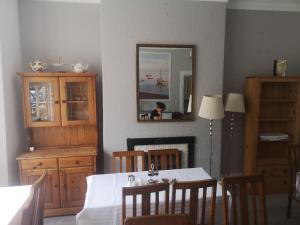 a dining room with a table and a mirror at The Sanderling in Morecambe