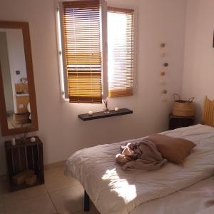 a person laying on a bed in a bedroom at Chambre à 500 m des remparts in Aigues-Mortes