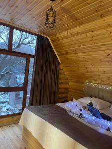 a bedroom with a bed and a large window at Riverside Eco Resort in Debed