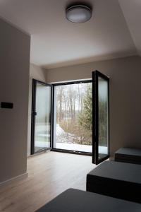 an empty room with a large window with a view at Dom przy molo in Augustów