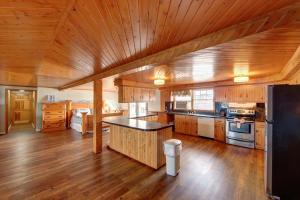 a large kitchen with wooden floors and a wooden ceiling at Blackbeard's Lodge in Ocracoke