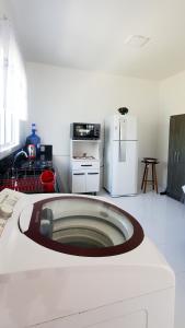 a kitchen with a white refrigerator and a stove at BALNEÁRIO GAIVOTA no AREIAS CLARAS in Sombrio