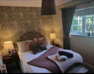 a bedroom with a bed with a towel on it at Blenheim House Hotel in Etwall