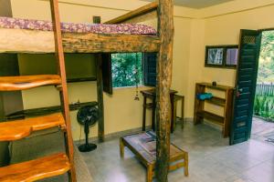a room with two bunk beds and a desk at Recanto Pitanga in Vale do Capao