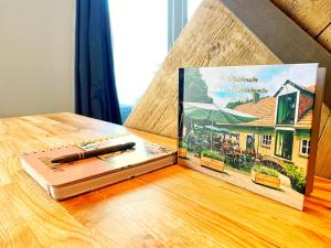 a book sitting on top of a table with a pen at B&B de Muldermolen in Schinnen +29 photos