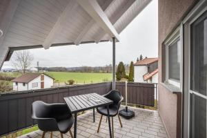 a patio with a table and chairs on a balcony at Ferienwohnung im Grünen, 10 km RV, 30 km Bodensee, Küche Bad Balkon in Mochenwangen