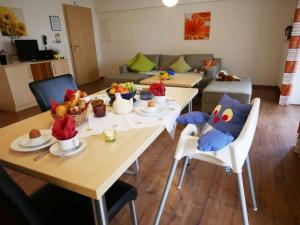 a living room with two tables with stuffed animals on them at Ferienwohnung 1 in Ochsenhausen