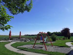 a playground with a swing set in a park at Ferienwohnung 1 in Ochsenhausen