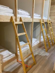 a room with three bunk beds in a room at COMPLEX TURISTIC AVENTURA CAMP in Eşelniţa