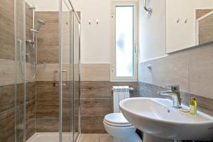 a bathroom with a sink and a toilet and a shower at Verdi 185 by Pleiades Home in Livorno +35 photos