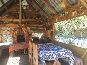 a room with a bed and a table in a house at Pensiunea Trei brazi Scărișoara in Scărişoara