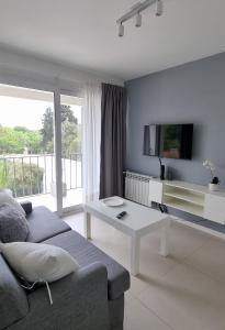 a living room with a couch and a table at NidoAparte II. Nuevo departamento en Lujan Centro in Luján