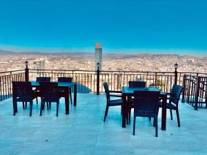 a group of tables and chairs on a balcony at LUXURY APARTMENT IN OLD TBILISI WITH TERRACe in Tbilisi City