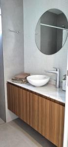 a bathroom with a sink and a mirror at NidoAparte II. Nuevo departamento en Lujan Centro in Luján