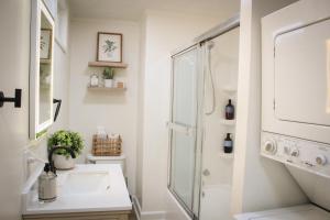 a white bathroom with a shower and a sink at New 1-bedroom Bungalow! 4 miles to CLE in Berea