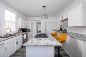 a kitchen with white cabinets and a counter top at Newly Renovated House-10 Minutes From Downtown in Cincinnati