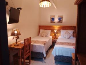 Cama ou camas em um quarto em Pousada Caminhos de Minas Belo Horizonte