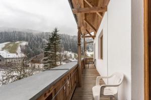 a balcony with a view of a snowy mountain at Schwüwong - Apartment 02 in Kelchsau