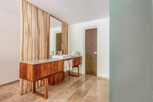 a bathroom with a sink and a mirror at The Explorean Cozumel All Inclusive in Cozumel