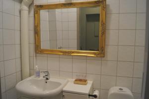 a bathroom with a sink and a mirror and a toilet at Jugend 1905 in Ålesund