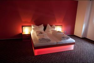 Giường trong phòng chung tại Hotel Galaxie