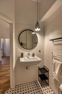 a bathroom with a sink and a mirror at Dwór Konstancin in Konstancin-Jeziorna