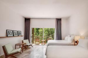 um quarto de hotel com duas camas e uma janela em The Explorean Cozumel All Inclusive em Cozumel
