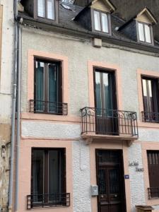 a building with balconies on the side of it at Le Val Fleuri in La Bourboule