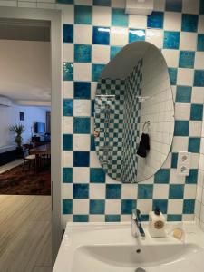 a bathroom with a sink and a mirror at Fotel Dunakanyar in Nagymaros