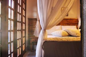 Cama ou camas em um quarto em Pousada Caminhos de Minas Belo Horizonte