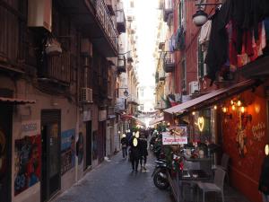 a narrow alley with people walking down a street at Domus Toledo in Naples