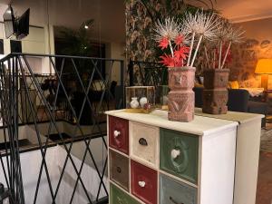 a dresser with three vases on top of it at Emiliadourohouse in Marco de Canaveses