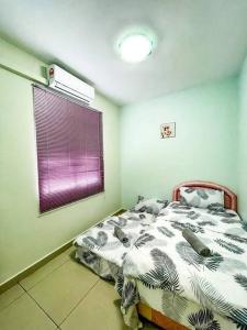 a bedroom with a bed and a purple window at Cybercity Ph1 near KKIA by Family Homestay in Donggongon
