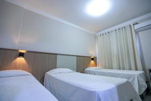 Cama ou camas em um quarto em Iguassu Express Hotel